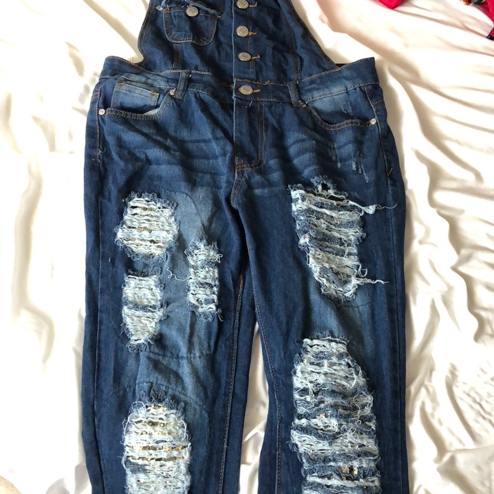 Ripped overalls with sequins under the rips